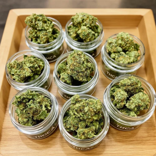 Affordable THCA flower in jars, showcasing the cheapest THCA flower online with visible trichomes and vibrant hues.