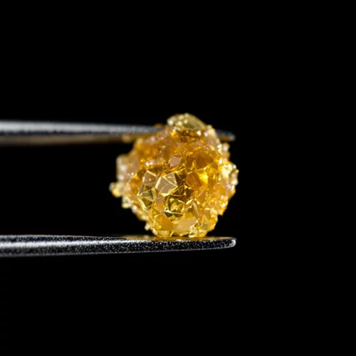 Close-up of a dab tool holding a pure amber THCA dab, highlighting the clean, concentrated texture of THCA dabs.