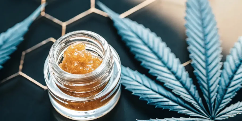 Golden THC live resin concentrate in glass jar