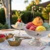 Gelato33 cannabis dessert table with colorful ice cream scoops and labeled jars at an outdoor summer gathering.
