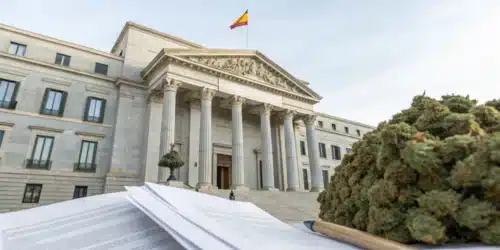 Realistic image of a Spanish government building with legal documents, symbolizing Spain cannabis laws and regulatory oversight.